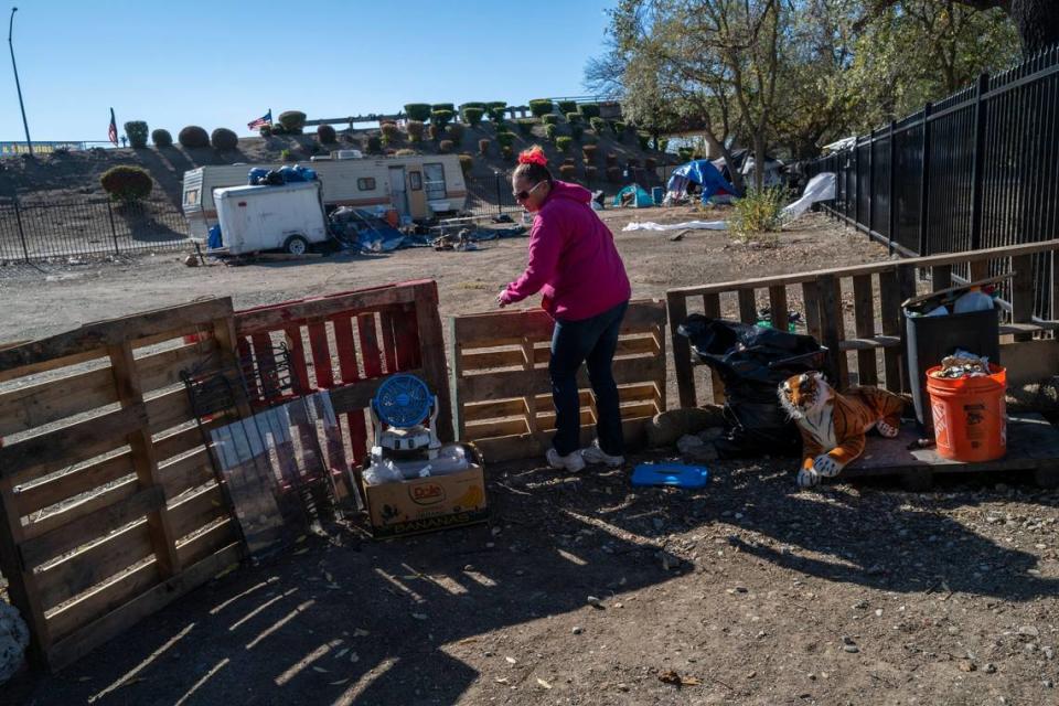Danyell Mayberry, 42, adjusts a makeshift fence she has for her dog at Camp Resolution in November 2022. Sacramento County District Attorney Thien Ho is demanding that residents of the Safe Ground site run by a nonprofit group and leased from the city be moved because of concerns that it is a toxic dump site.