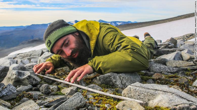 <p>An archaeologist surveys a glacier in Norway</p> (Glacier Archaeology Programme, Innlandet County Council)