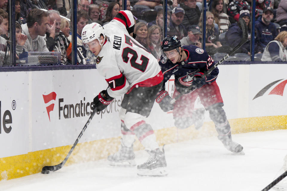Ottawa Senators left wing Parker Kelly (27) controls the puck against Columbus Blue Jackets defenseman Jake Bean (22) during the first period of an NHL hockey game Thursday, March 14, 2024, in Columbus, Ohio. (AP Photo/Jeff Dean)