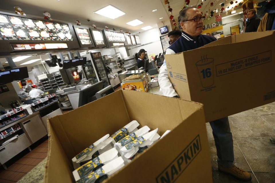 Doctor Angelo picks up boxes of food and coffee at a restaurant to deliver to homeless people in Chicago