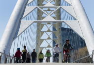 People get exercise outside on the lake shore path along Lake Ontario in Toronto on Thursday, April 2, 2020. Health officials and the government has asks that people stay inside to help curb the spread of the coronavirus also known as COVID-19. (Nathan Denette/The Canadian Press via AP)