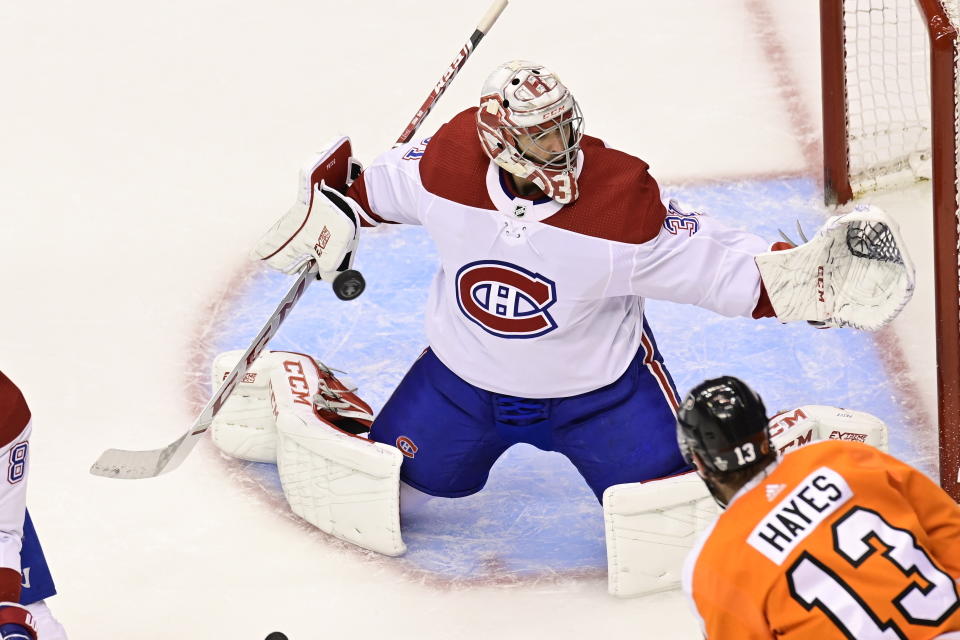 Montreal Canadiens goaltender Carey Price (31) makes save as Philadelphia Flyers centre Kevin Hayes (13) looks on during the second period of an NHL Eastern Conference Stanley Cup hockey playoff game in Toronto, Friday, Aug. 14, 2020. (Frank Gunn/The Canadian Press via AP)
