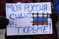 A woman holds a banner that reads in Russian: "My Russia sitting in prison!" during a rally in support of Russia's political prisoners in Belgrade, Serbia, Saturday, Jan. 21, 2023. A friendly, fellow-Slavic nation, Serbia has welcomed the fleeing Russians who need visas to travel to much richer Western European states. But in Serbia, they have not escaped the long reach of Putin's hardline regime influence.(AP Photo/Darko Vojinovic)