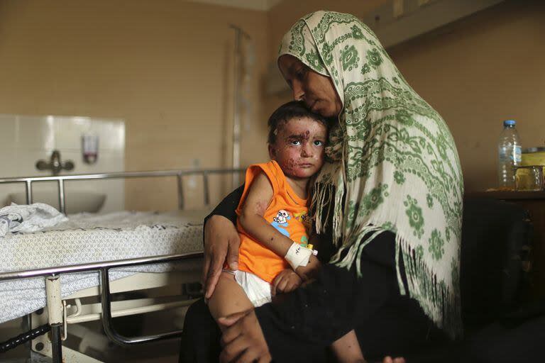 Mohammed Wahdan, herido tras un bombardeo israelí, en brazos de su tía en el hospital Shifa en Gaza