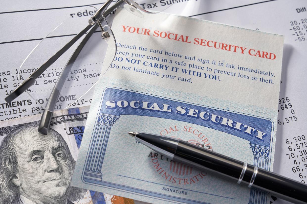 social security card with money, pen, glasses, and $100 bill