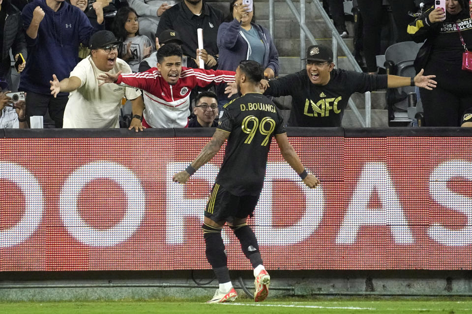 Los Angeles FC forward Denis Bouanga celebrates with fans his first goal against Minnesota United, during the first half of a Major League Soccer match Wednesday, Oct. 4, 2023, in Los Angeles. (AP Photo/Mark J. Terrill)