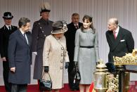 <p>As a former fashion model, Carla Bruni (who's also the wife of former French president, Nicolas Sarkozy) knows how to dress for royalty. She wore a grey belted coat dress and matching pillbox hat when she visited London in 2008. </p>