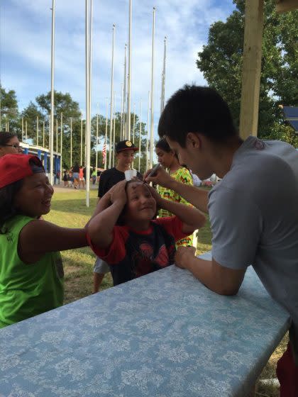 Bronson Koenig signs a young fan&#39;s forehead at the Ho-Chunk Powwow earlier this month (via Clint Parks)