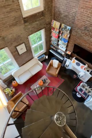 <p>Caleb Simpson/TikTok</p> View of the living room and vinyl wall.