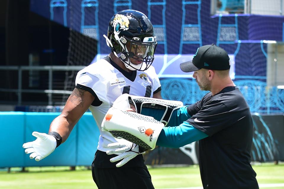 Jaguars first round draft pick (44) OLB Travon Walker works on technique with outside linebackers coach Bill Shuey Friday afternoon during Rookie Minicamp. The Jacksonville Jaguars held their first Rookie Minicamp on the turf of TIAA Bank Field Friday afternoon, May 13, 2022. Among those in attendance were the team's 2022 draft picks. [Bob Self/Florida Times-Union]