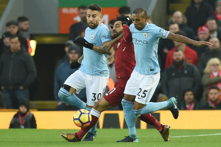 Manchester City's Nicolas Otamendi (L) and Fernandinho (R) try to intercept Liverpool's Mohamed Salah during their English Premier League match, at Anfield in Liverpool, on January 14, 2018