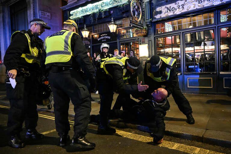 Police officers detain a man in the street by Whitehall close to the 'National March For Palestine' in central London on November 11, 2023, as counter-protest groups are monitored by police close to the route of the main march. About 300,000 people marched through the British capital, as pro-Palestinian supporters made a new call for a Gaza war ceasefire. Authorities had feared trouble as the 