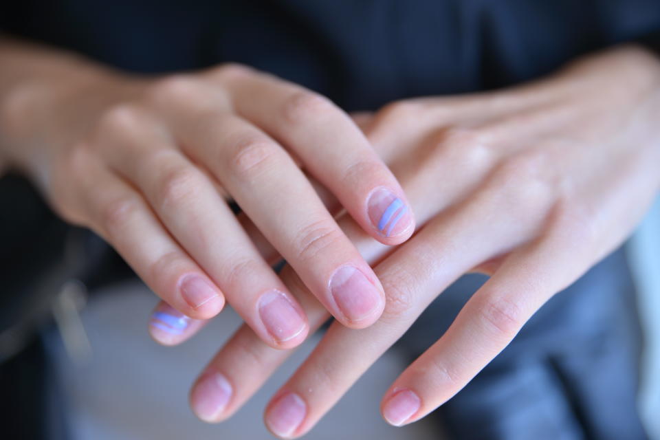 <p>Jin Soon Choi went for the unexpected with a single bold stripe accent on one nail in a shade of purple or black. To get this look: yse a striping tool to make one stripe bolder than the other. Depending on your mood, you can draw it on horizontally or vertically. (Photo: Essie) </p>