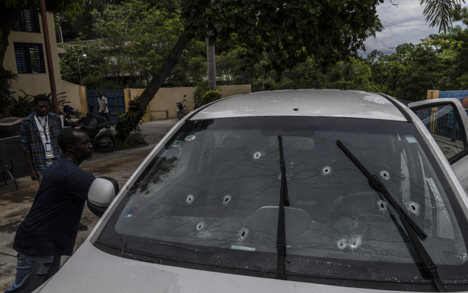 Bullet holes cover the windshield of journalist Roberson Alphonse's car after he was attacked in Port-au-Prince, Haiti, Tuesday, Oct. 25, 2022. Alphonse, who works at the daily newspaper Le Nouvelliste and radio station Magik9, is hospitalized but is expected to recover, according to Frantz Duval, chief editor for both media. He said Alphonse has undergone two operations so far.(AP Photo/Ramon Espinosa)