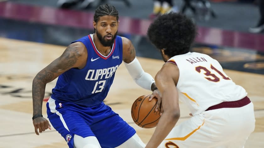 Los Angeles Clippers' Paul George (13) drives to the basket against Cleveland Cavaliers' Jarrett Allen.