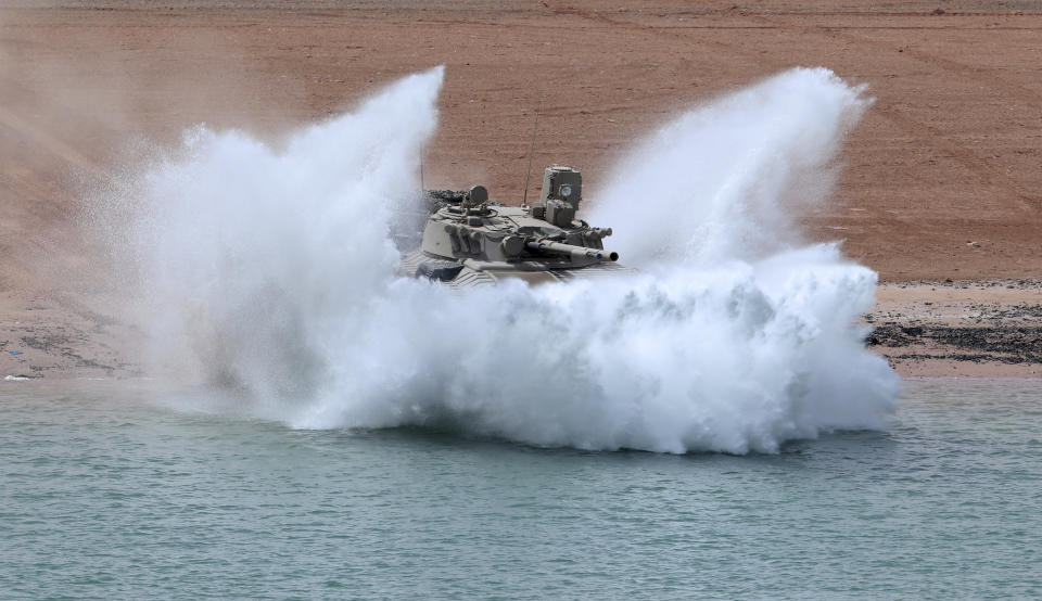 An Emirati armored personnel carrier charges into a canal during an exercise at an Emirati military base home to a Military Operations in Urban Terrain facility in al-Hamra, United Arab Emirates, Monday, March 23, 2020. The U.S. military held the major exercise Monday with Emirati troops in the UAE's far western desert at a facility designed to look like a Mideast city amid ongoing tensions with Iran. (AP Photo/Jon Gambrell)