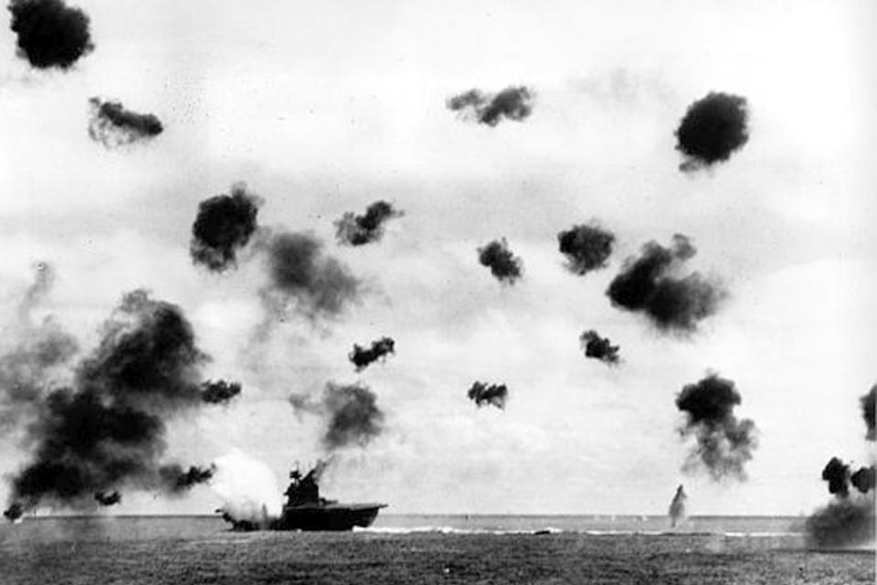 FILE - Smoke billows from the USS Yorktown and bursts from anti-aircraft fire fill the air after a Japanese bomber hit the aircraft carrier in the Battle of Midway near Midway Islands during World War II in June 1942. Footage from remote submersibles taken three miles under the Pacific Ocean is giving the world the first detailed glimpse of three World War II aircraft carriers that sunk in the pivotal Battle of Midway, which marked a shift in control of the Pacific naval theater from Japanese to U.S. forces. (U.S. Navy via AP, File)