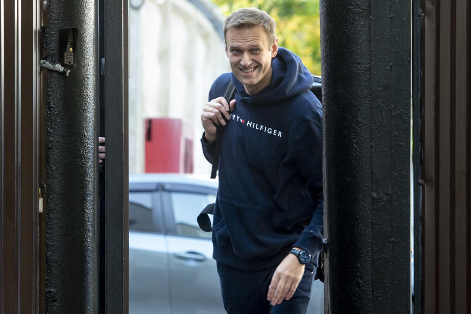 Russian opposition leader Alexei Navalny leaves a detention center after been released, in Moscow, Russia, Friday, Aug. 23, 2019. Navalny, the Kremlin's most prominent foe, was sentenced last month to 30 days for calling on people to take part in an unauthorized protest. (AP Photo/Dmitry Serebryakov)