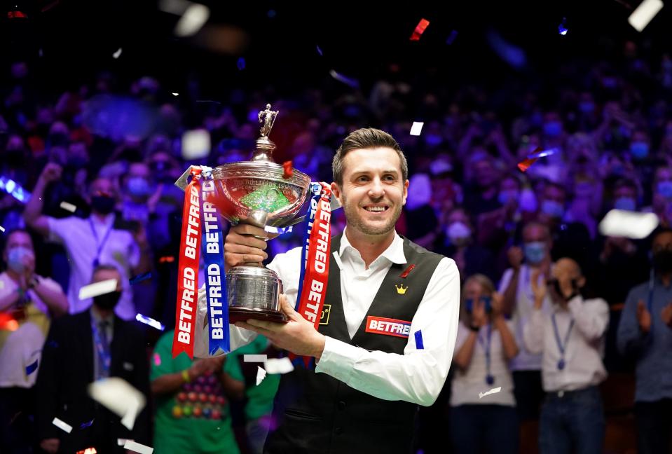 Mark Selby celebrates with the World Snooker Championship trophy (PA)