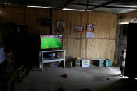 A TV shows a friendly soccer game of Peru versus Saudi Arabia, at the Mendez family home at Nueva Union shantytown in Villa Maria del Triunfo district of Lima, Peru, June 3, 2018. REUTERS/Mariana Bazo