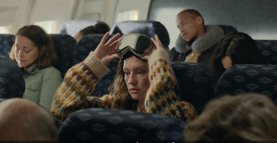 Woman wearing Apple Vision Pro on a plane