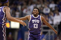 TCU guard Shahada Wells (13) looks to slap hands with forward Xavier Cork (12) during the second half of an NCAA college basketball game on Saturday, Jan. 21, 2023, at Allen Fieldhouse in Lawrence, Kan. TCU defeated Kansas, 83-60. (AP Photo/Nick Krug)