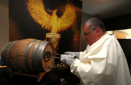 Norbertine Father Karel marks a barrel of Grimbergen beer, symbolised by a phoenix, at the Belgian Abbey of Grimbergen after announcing that the monks will return to brewing after a break of two centuries, in Grimbergen, Belgium May 21, 2019. REUTERS/Yves Herman