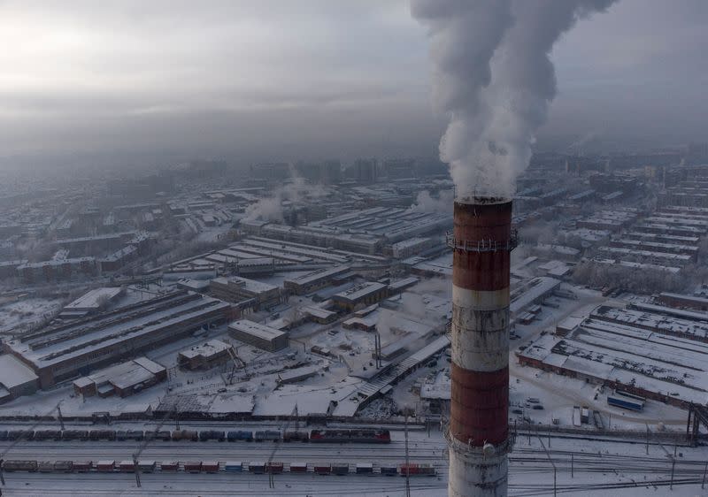 FILE PHOTO: Smoke billows from a chimney in the city of Omsk