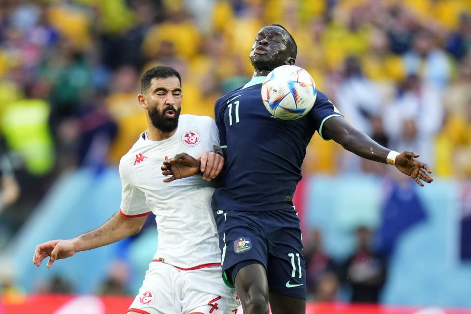 Tunisia's Yassine Meriah, left, and Australia's Awer Mabil fight for the ball during the World Cup group D soccer match between Tunisia and Australia at the Al Janoub Stadium in Al Wakrah, Qatar, Saturday, Nov. 26, 2022. Australia won 1-0. (AP Photo/Petr David Josek)