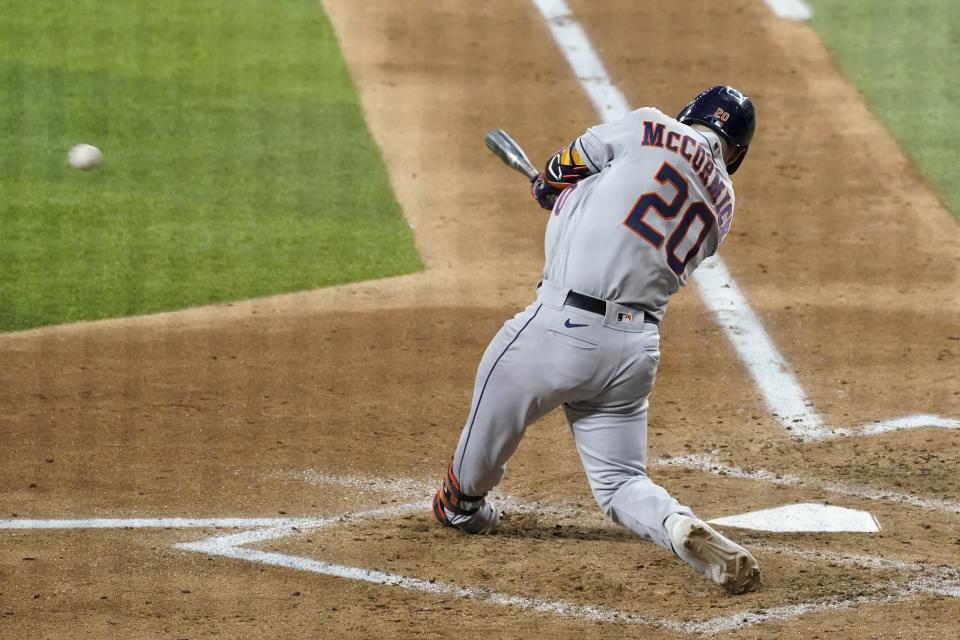 Houston Astros' Chas McCormick (20) follows through on a two-run single in the fourth inning of a baseball game against the Texas Rangers in Arlington, Texas, Wednesday, Sept. 15, 2021. The hit scored Kyle Tucker and Yuli Gurriel. (AP Photo/Tony Gutierrez)
