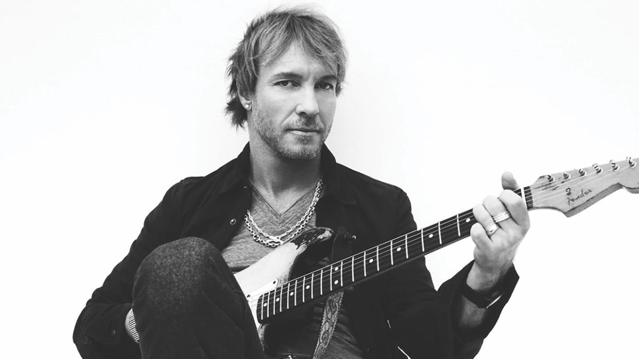  Kenny Wayne Shepherd black and white portrait as he plays an electric guitar. 