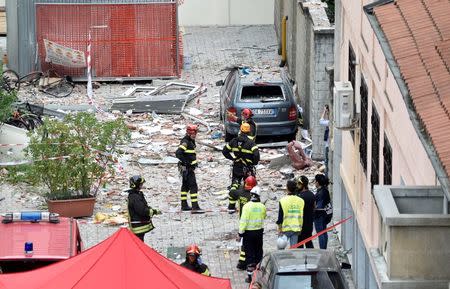 Italian firefighters work in the debris after a residential building partially collapsed on Sunday following an explosion in Milan, Italy, June 12, 2016. REUTERS/Flavio Lo Scalzo