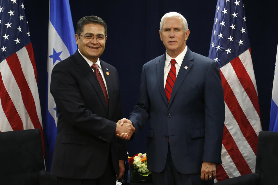 FILE - In this June 15, 2017 file photo, Honduras' President Juan Orlando Hernandez, left, shakes hands with U.S. Vice President Mike Pence during a conference on Prosperity and Security in Central America in Miami. Hondurans wonder how long the U.S. government can stick with Hernández, as U.S. prosecutors promise that in a trial in October evidence will show Hernández harnessed his brother's drug trafficking connections to propel his own political fortunes. (AP Photo/Wilfredo Lee, Pool, File)