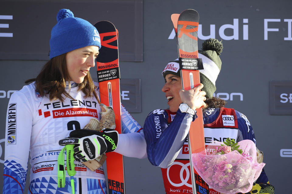 First placed Slovakia's Petra Vlhova, left and first placed Italy's Federica Brignone celebrate on the podium at the end of an alpine ski, World Cup women's giant slalom in Sestriere, Italy, Saturday, Jan. 18, 2020. Federica Brignone and Petra Vlhova have tied for a World Cup giant slalom victory while overall leader Mikaela Shiffrin finished third by the smallest of margins. (AP Photo/Marco Trovati)