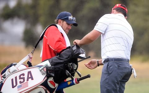  Patrick Reed and his caddie, Kessler Karain, left, play a practice round for the President's Cup golf tournament at Royal Melbourne Golf  - Credit: &nbsp;AP