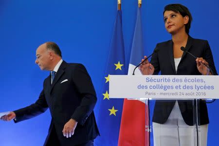 French Interior Minister Bernard Cazeneuve (L) and Education Minister Najat Vallaud-Belkacem attend a news conference to announce security plans for schools, in Paris, France, August 24, 2016. REUTERS/Pascal Rossignol