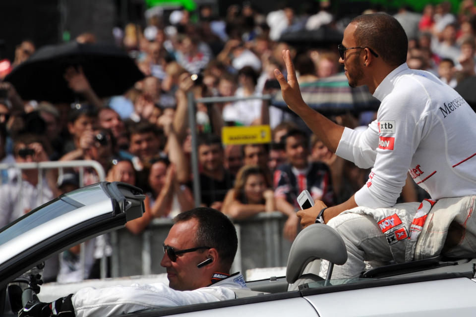 McLaren Mercedes' British driver Lewis Hamilton (R) attends at the "Moscow City Racing" show on July 16, 2015 in central Moscow. AFP PHOTO / KIRILL KUDRYAVTSEVKIRILL KUDRYAVTSEV/AFP/GettyImages