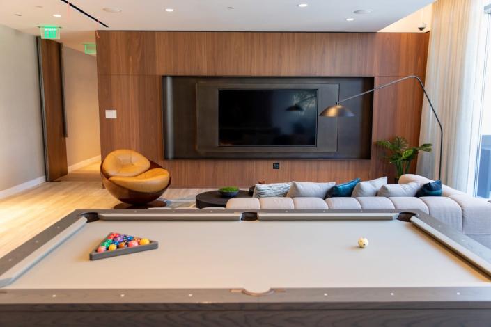 The Grand Lounge bar and theater features a custom billiards table and 85-inch TV.