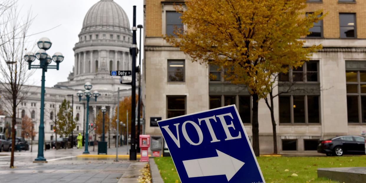 FILE PHOTO: A sign directs voters towards a polling place near the state capitol in Madison, Wisconsin, U.S. November 6, 2018. REUTERS/Nick Oxford