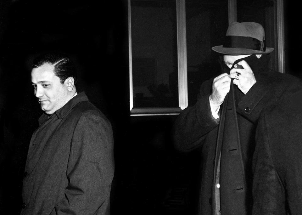 Camera-shy Henry F. “Buster” Bell, right, international vice president of the Longshoremen’s Union, hides his face as he walks down the corridor at the Federal Courthouse in Nashville Feb. 1, 1963. Charles "Chucky" O’Brien, Detroit Teamster official walks beside him. Bell took the Fifth Amendment 54 times before a federal grand jury investigating jury tampering during the past trail of James Hoffa here.