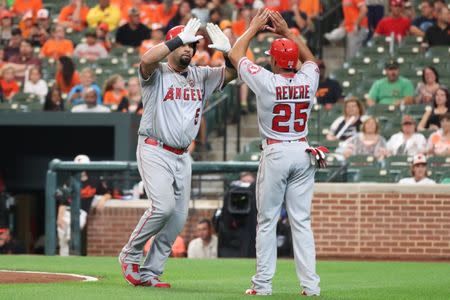 Aug 18, 2017; Baltimore, MD, USA; Los Angeles Angels designated hitter Albert Pujols (5) greeted by outfielder Ben Revere (25) after connecting on a two run home run against the Baltimore Orioles at Oriole Park at Camden Yards. Mitch Stringer-USA TODAY Sports