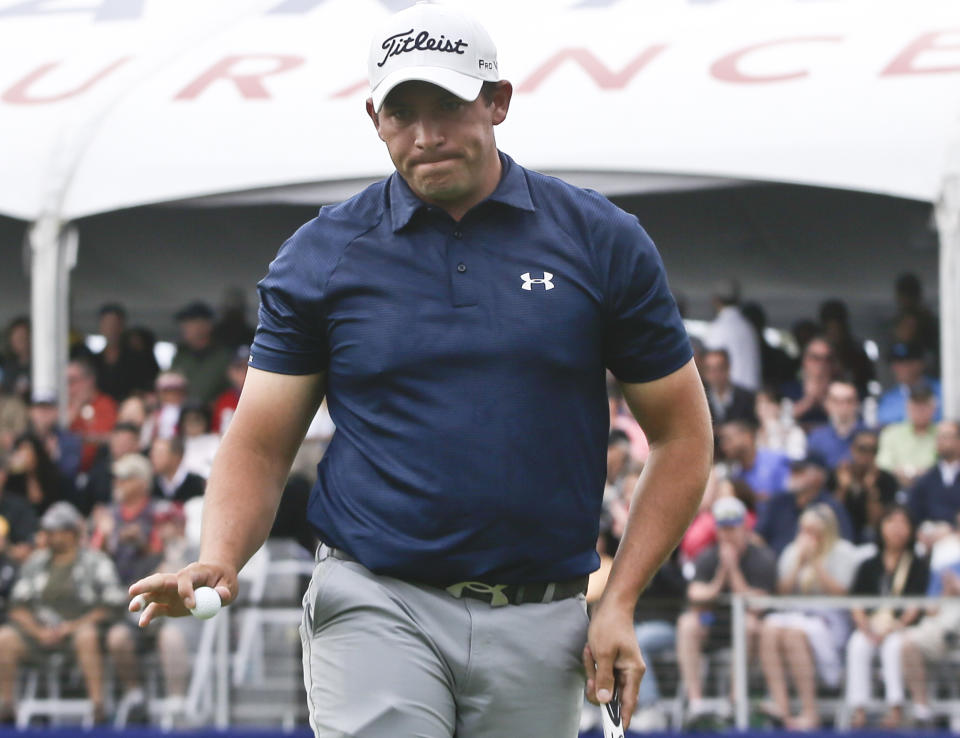 Scott Stallings acknowledges the applause as he walks off the 17th green of the South Course at Torrey Pines during the final round of the Farmers Insurance Open golf tournament, Sunday, Jan. 26, 2014, in San Diego. Stallings won the tournament. (AP Photo/Lenny Ignelzi)