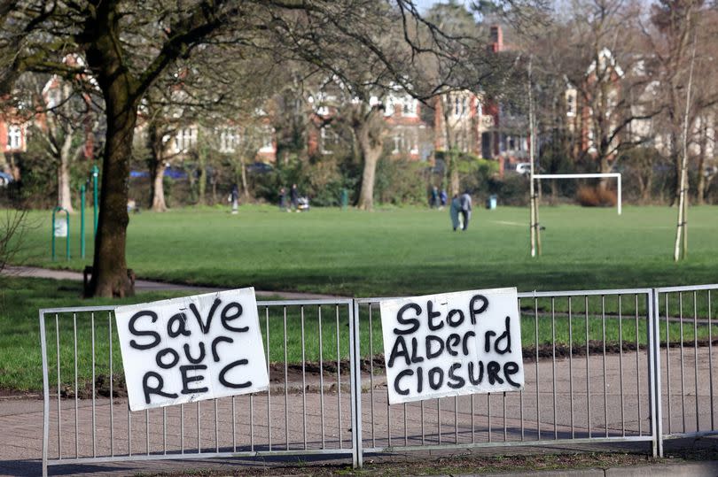 Signs stuck to fences read "SAVE OUR REC" and "STOP ALDER RD CLOSURE"