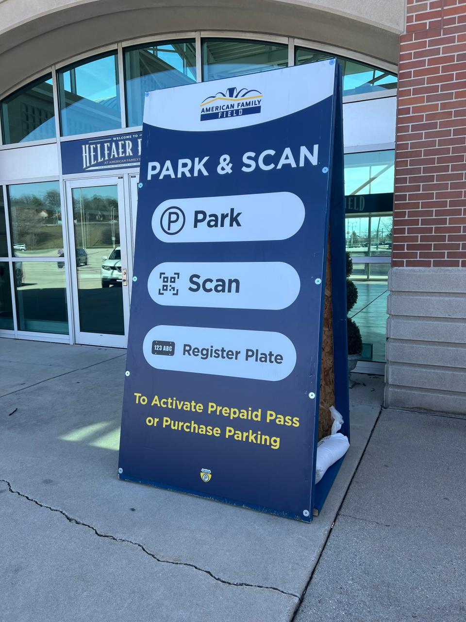 A sign showing how to use American Family Field's new QR code-based parking payment system.