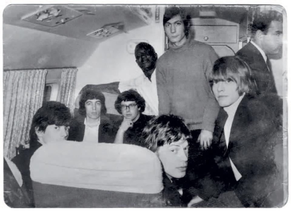 The Rolling Stones at home, with Mankowitz (center, wearing glasses)