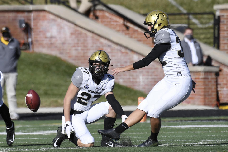 Vanderbilt's Sarah Fuller, right, kicks off as Ryan McCord (27) holds to start the second half of an NCAA college football game against Missouri on November 28, 2020, in Columbia, Missouri.  / Credit: L.G. Patterson/AP