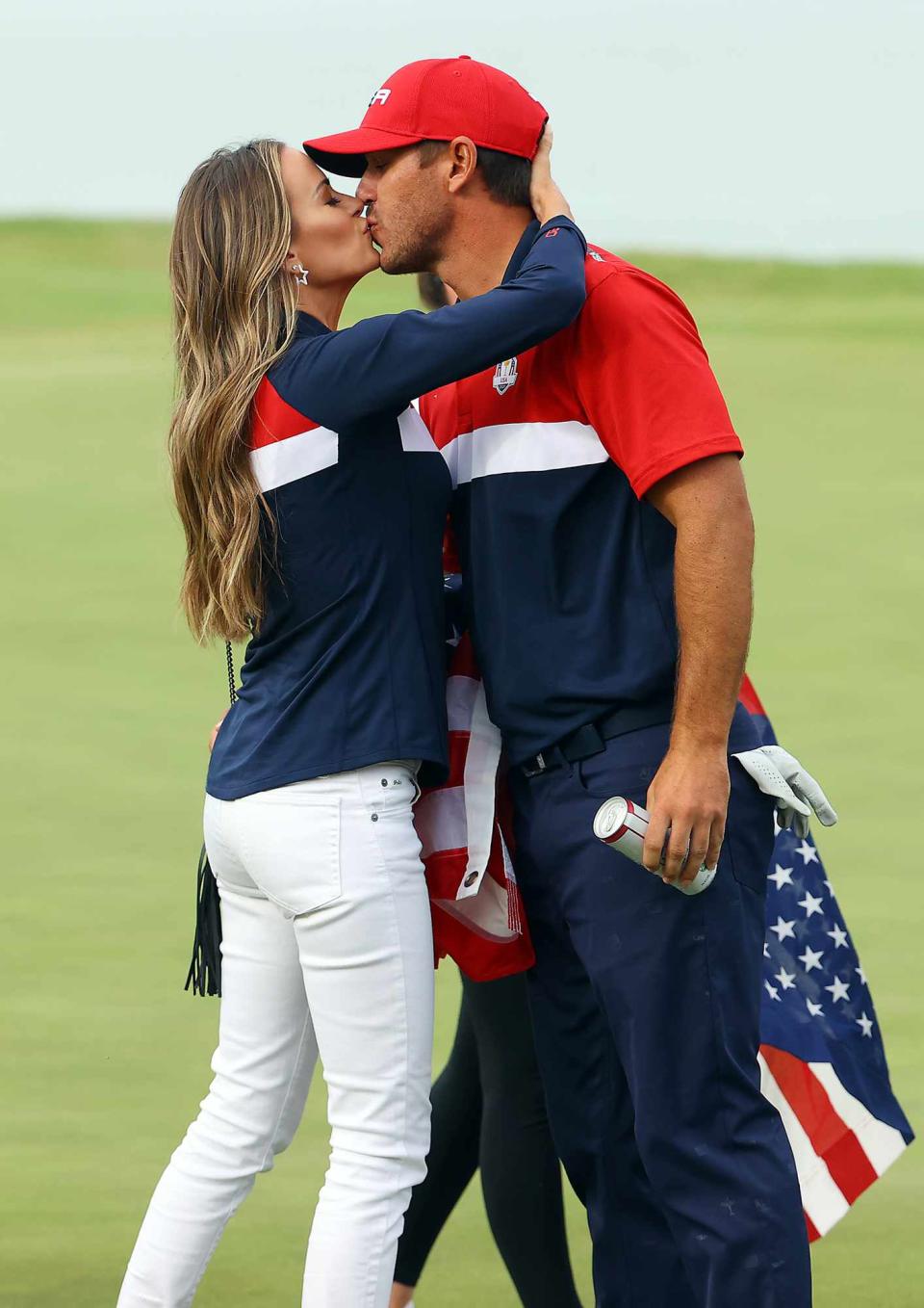 Brooks Koepka of team United States celebrates with wife Jena Sims after winning his match on the 17th green during Sunday Singles Matches of the 43rd Ryder Cup at Whistling Straits on September 26, 2021 in Kohler, Wisconsin.