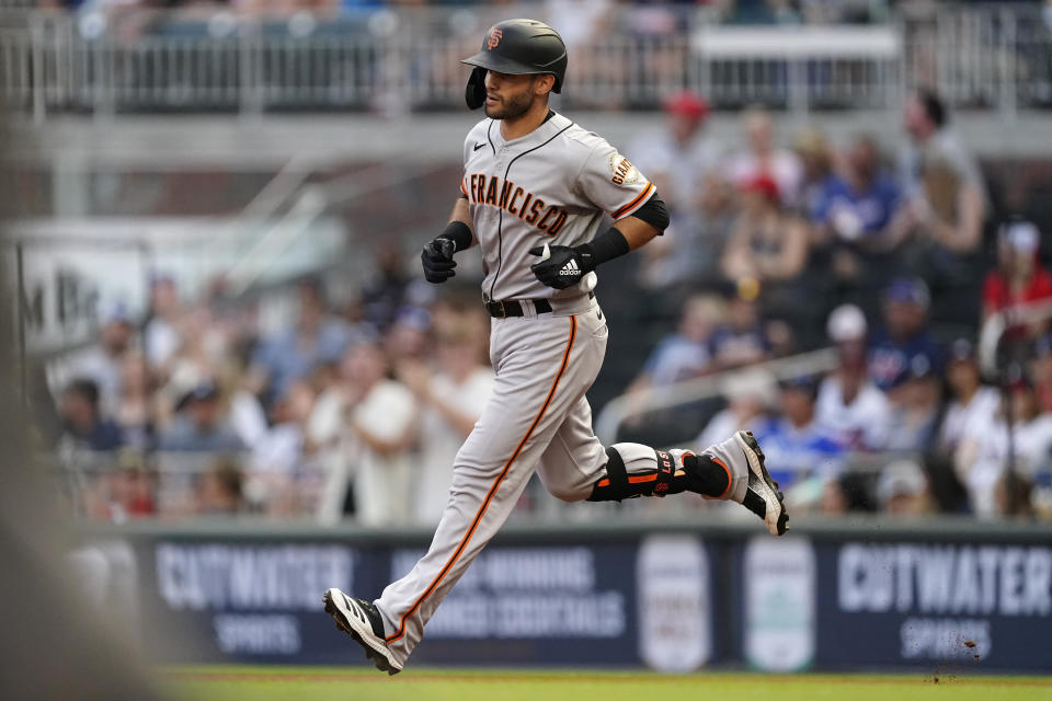 San Francisco Giants' Tommy La Stella rounds the bases after hitting a home run during the first inning of the team's baseball game against the Atlanta Braves on Saturday, Aug. 28, 2021, in Atlanta. (AP Photo/John Bazemore)