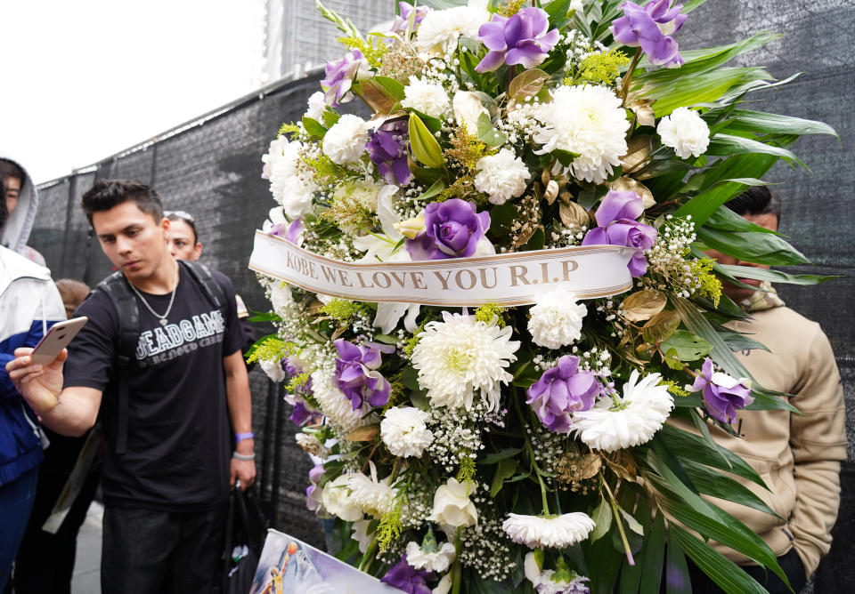 Flowers and tributes are left at a makeshift memorial for former NBA player Kobe Bryant outside the 62nd Annual GRAMMY Awards at STAPLES Center on January 26, 2020 in Los Angeles, California. Bryant, 41, died today in a helicopter crash in near Calabasas, California. (Photo by Rachel Luna/Getty Images)