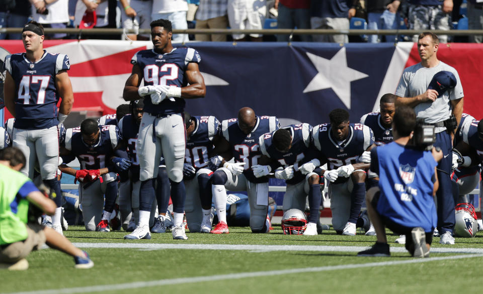 Members of the New England Patriots take a knee during the national anthem before a game against the Houston Texans at Gillette Stadium.&nbsp; (Photo: USA Today Sports / Reuters)